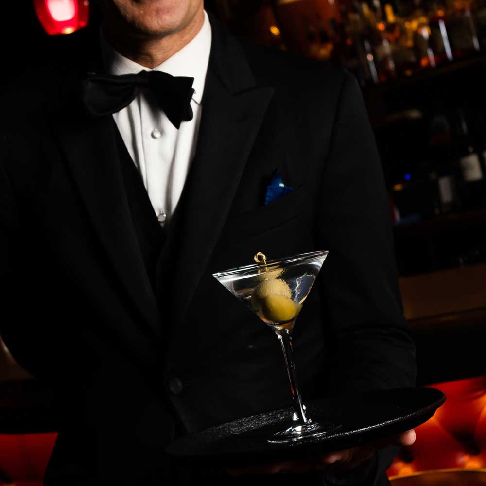 El Gaucho Waiter holding Cocktail